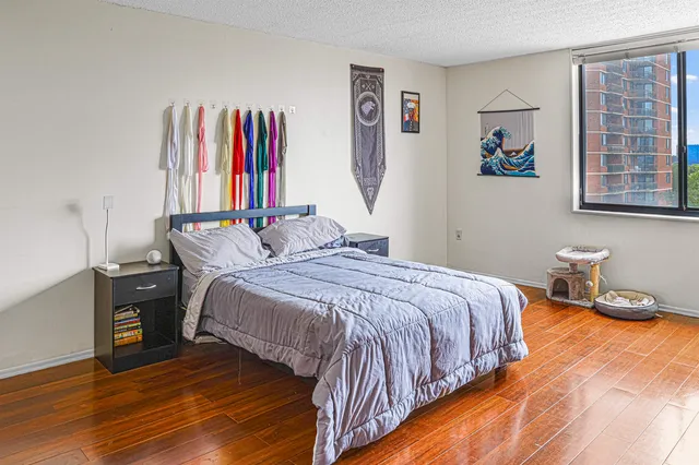 a bedroom with a bed and a large window