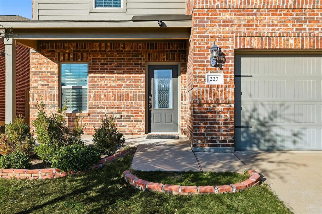 227 Curt Street Anna, TX 75409 - Photo 2 of 40 Entrance to property featuring a garage and brick siding
