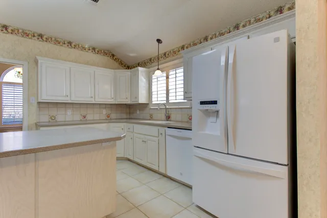a kitchen with cabinets and appliances
