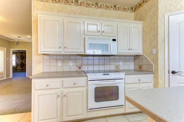 a bathroom with a granite countertop sink a mirror and a shower
