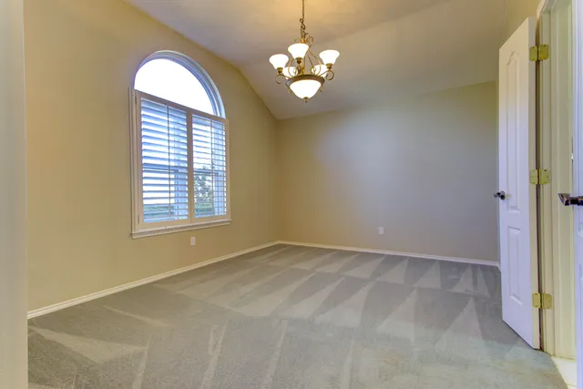 an empty room with a empty space and windows