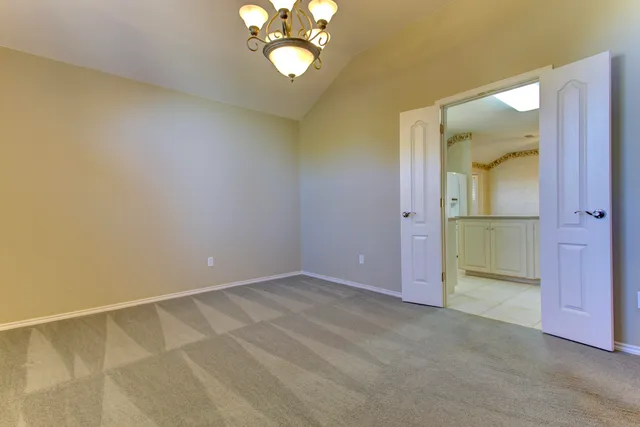 an empty room with a empty space and windows