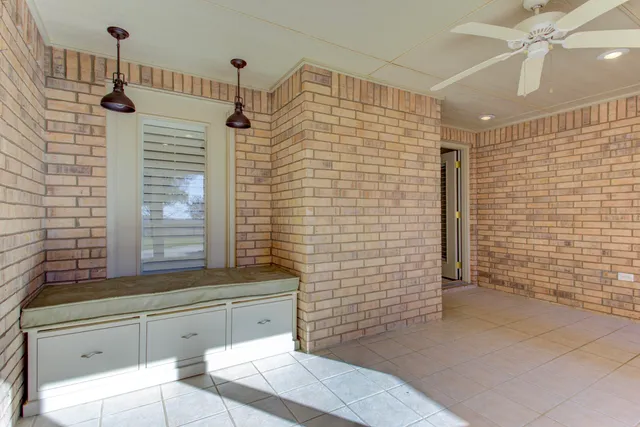 a backyard of a house with wooden fence and trees