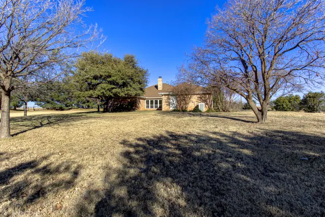 an empty room with entrance and windows