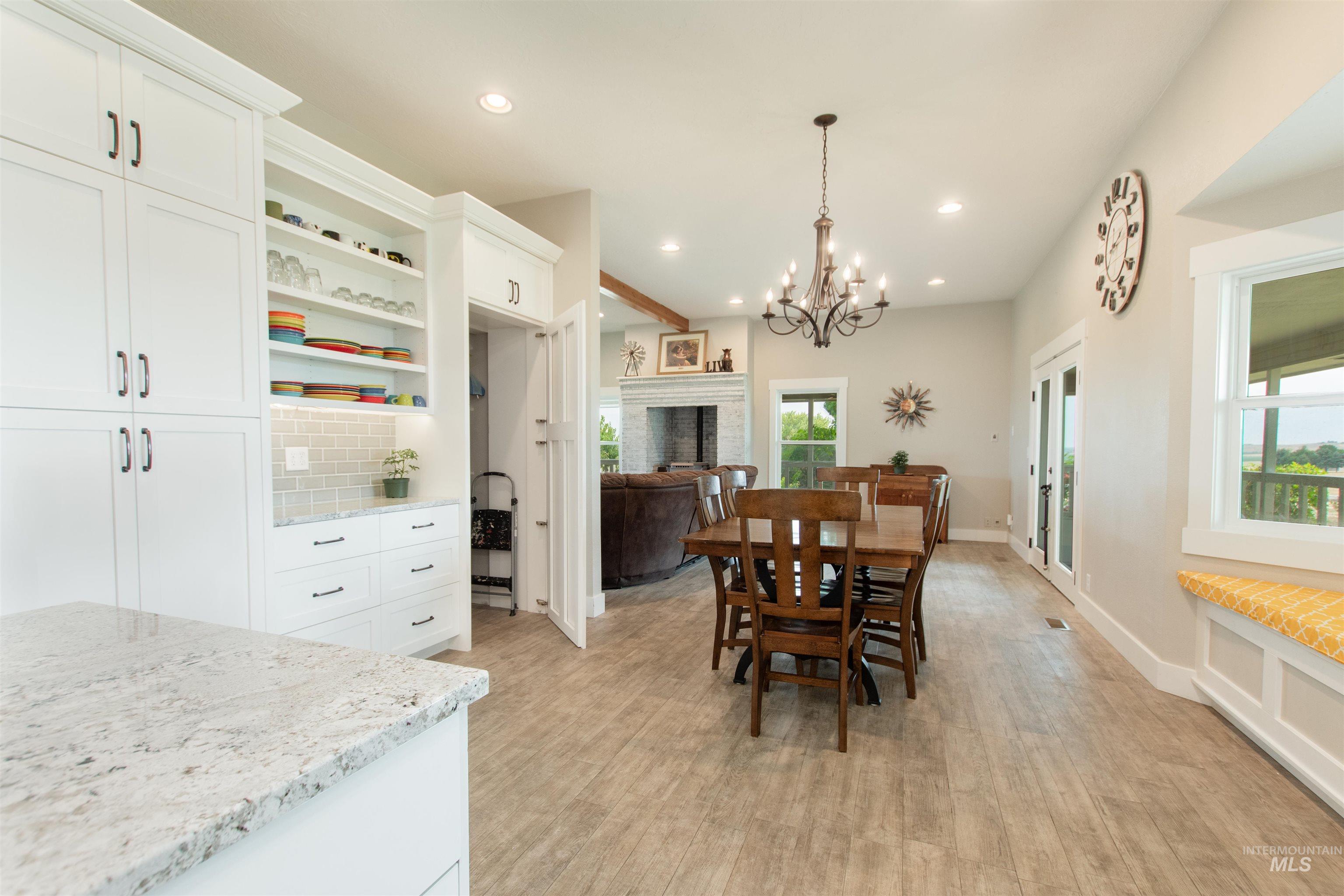 12369 Deer Flat Road Nampa, ID 83686 - Photo 19 of 50 Versatile interior space featuring concrete flooring, multiple rectangular ceiling light fixtures, and white paneled garage doors with upper window inserts