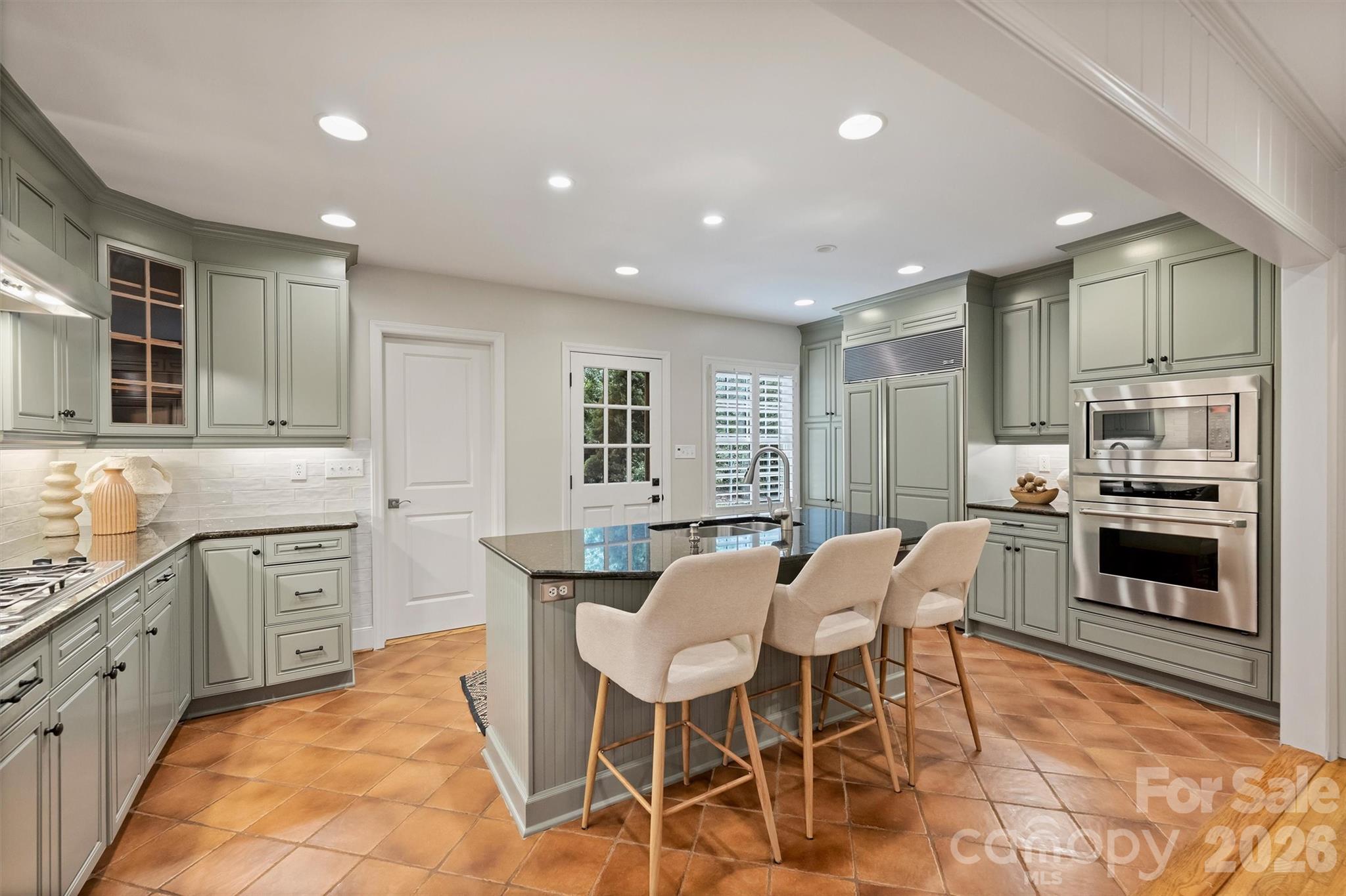 5519 Robinhood Road Charlotte, NC 28211 - Photo 17 of 46 a kitchen with a table chairs refrigerator and cabinets