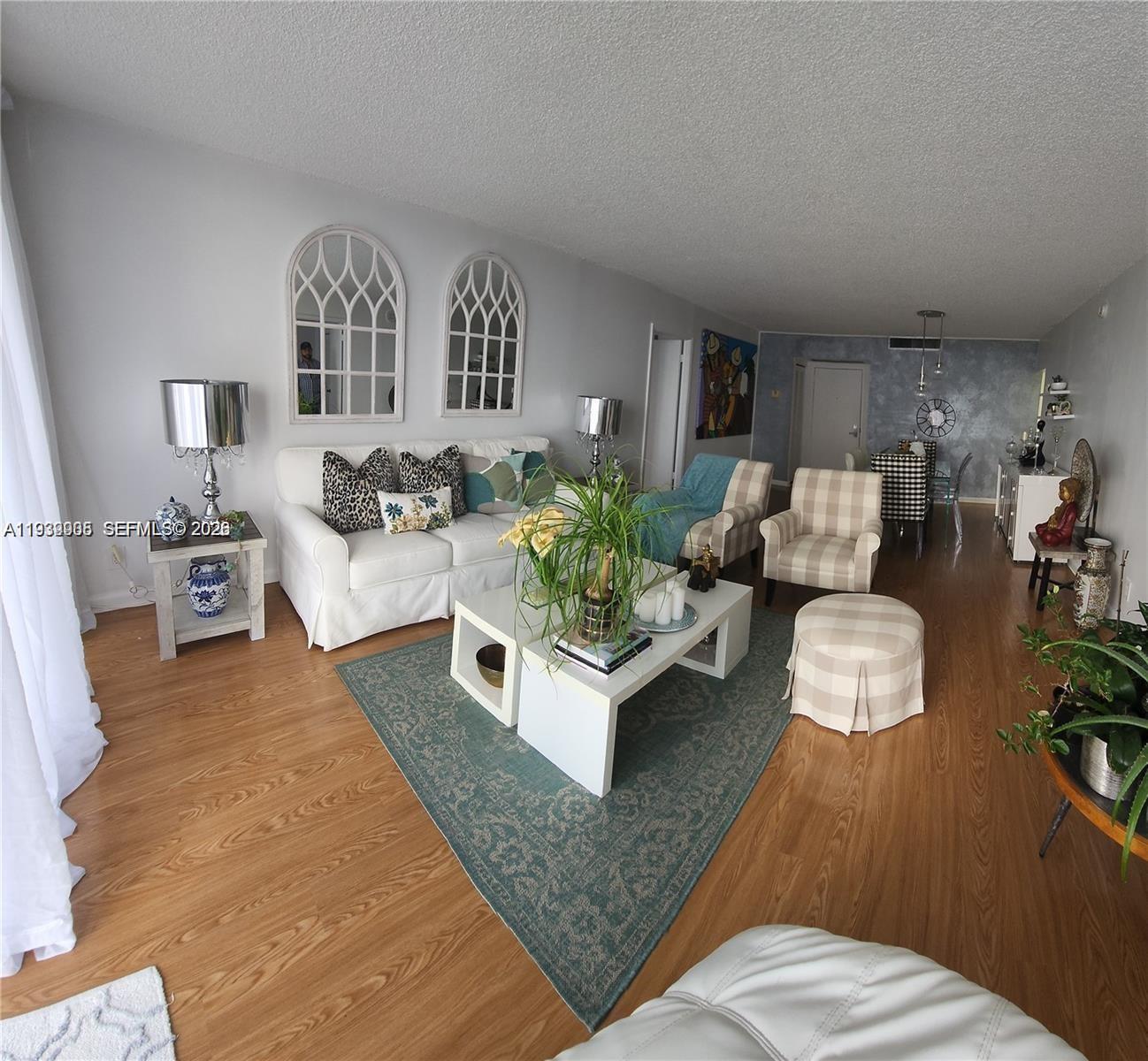 780 Northeast 69th Street, Unit 1207 Miami, FL 33138 - Photo 4 of 12 a living room with furniture and a couch