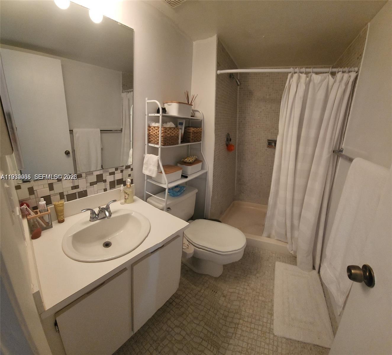 780 Northeast 69th Street, Unit 1207 Miami, FL 33138 - Photo 8 of 12 a bathroom with a sink toilet and shower