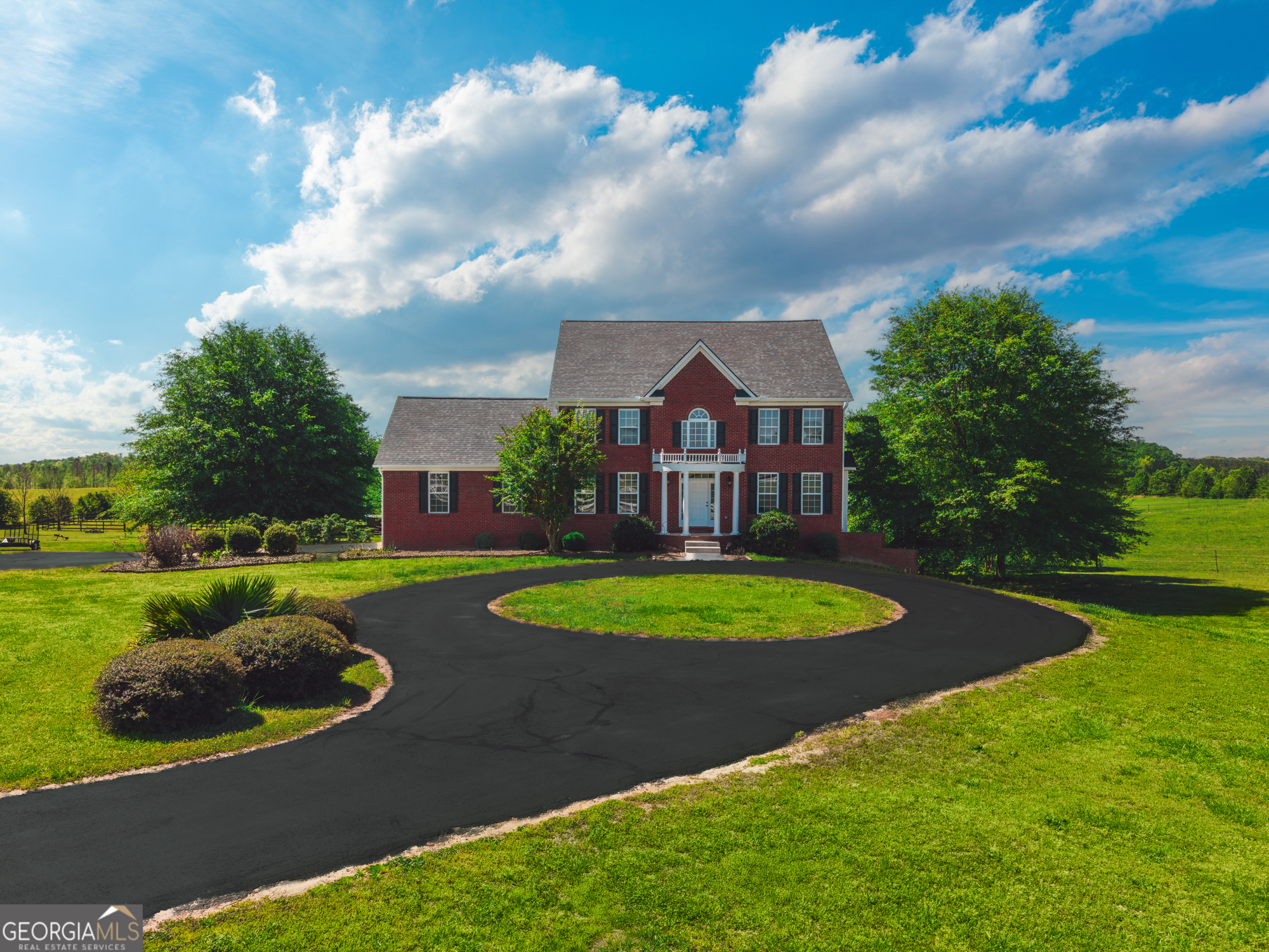 724 Teamon Road Griffin, GA 30223 - Photo 4 of 50 a view of a white house with a big yard plants and large trees