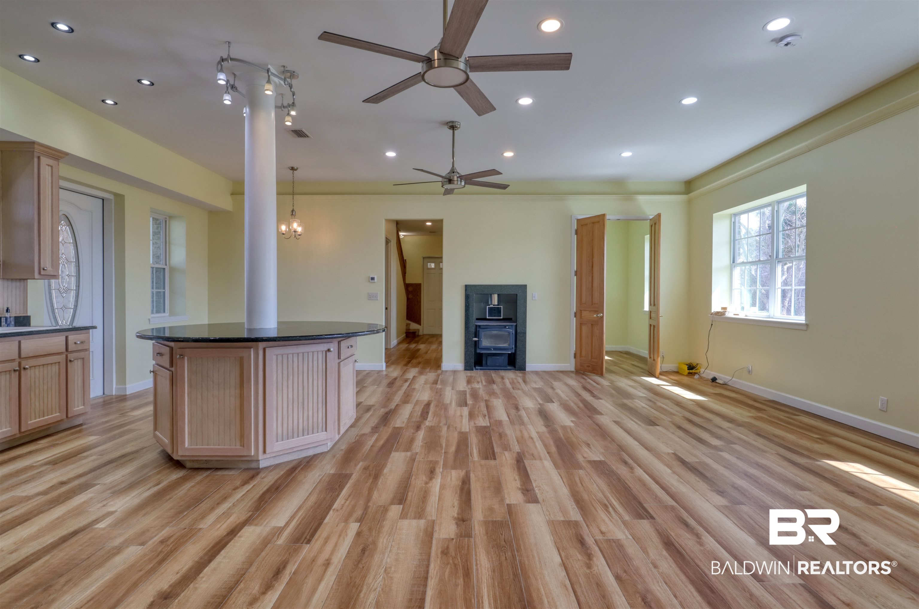 28461 Gardner Road Elberta, AL 36530 - Photo 44 of 46 Kitchen featuring open floor plan, recessed lighting, light wood-type flooring, dark stone counters, and a center island
