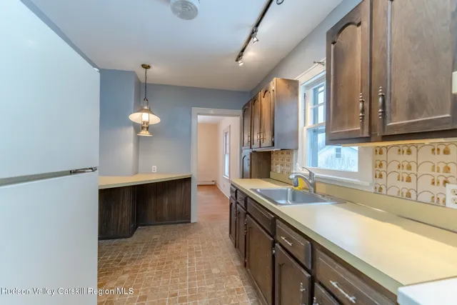 a kitchen with stainless steel appliances a sink and a stove