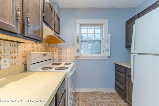 a kitchen with stainless steel appliances granite countertop a sink and a stove