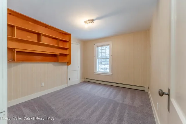 a view of room with hardwood floor and window