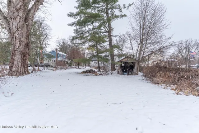 a view of a yard covered in snow