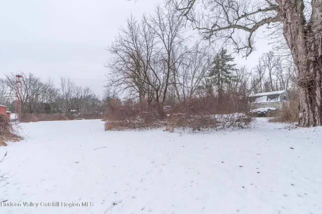 a view of a yard covered with snow in the background