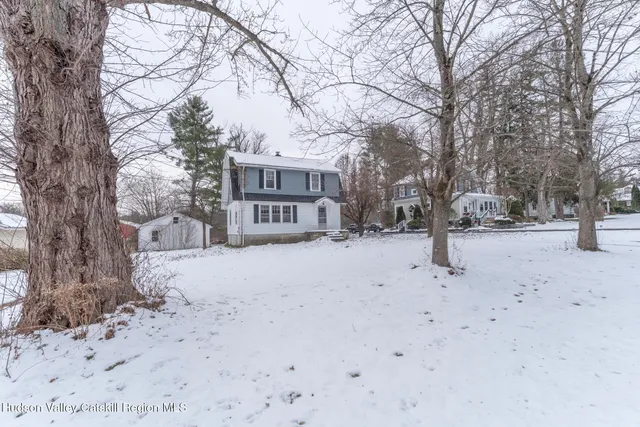 a view of a house with snow on the road