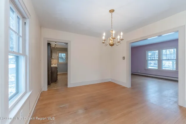 a view of a chandelier in big room and windows