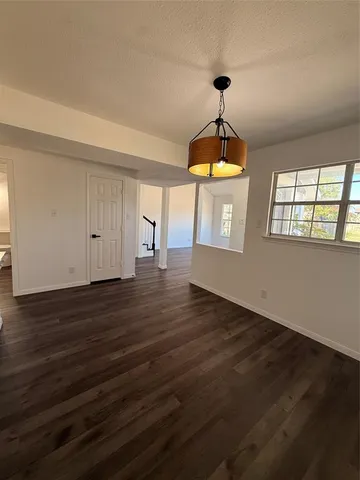 a very nice looking room with wooden floor windows and a chandelier