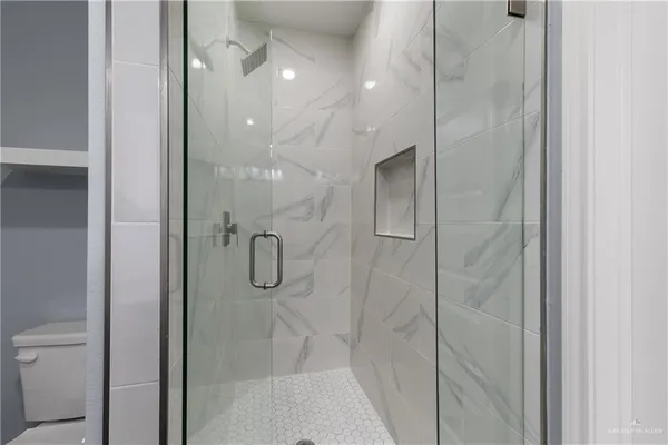 a bathroom with a glass shower door