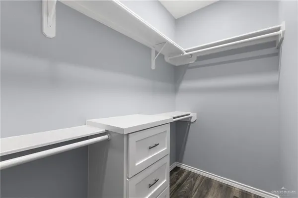 a utility room with cabinets washer and dryer