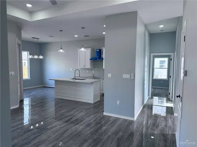 a view of kitchen with cabinets and wooden floor