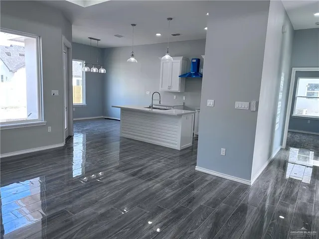 a view of kitchen and hall with wooden floor