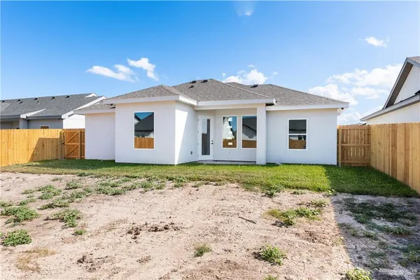a view of a house with a backyard