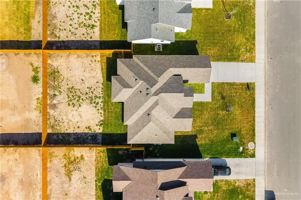 an aerial view of a house with a yard swimming pool and outdoor seating