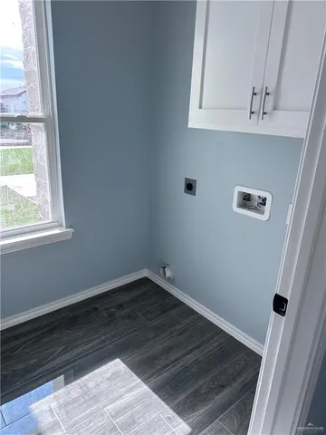 a view of a small space with wooden floor and a window