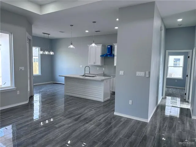 a room with a wooden floor and staircase