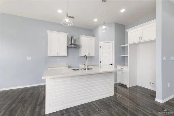 a kitchen with a sink stainless steel appliances and cabinets