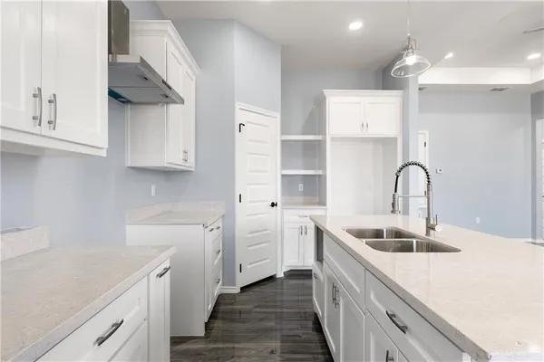 a kitchen with a sink and cabinets