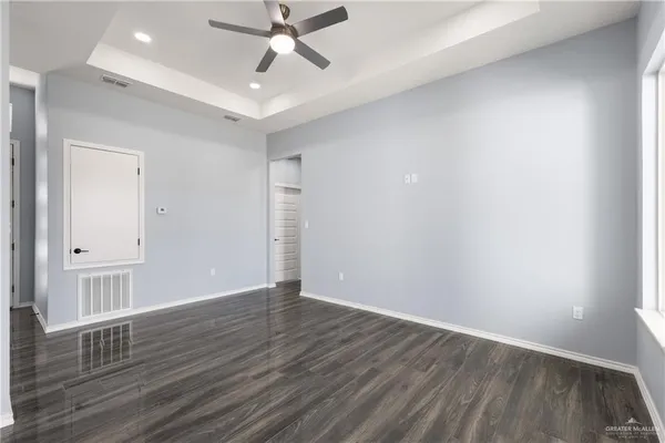a view of an empty room and wooden floor