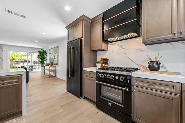 a kitchen with stainless steel appliances granite countertop a stove microwave and refrigerator