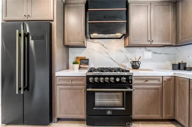 a kitchen with stainless steel appliances white cabinets and a stove