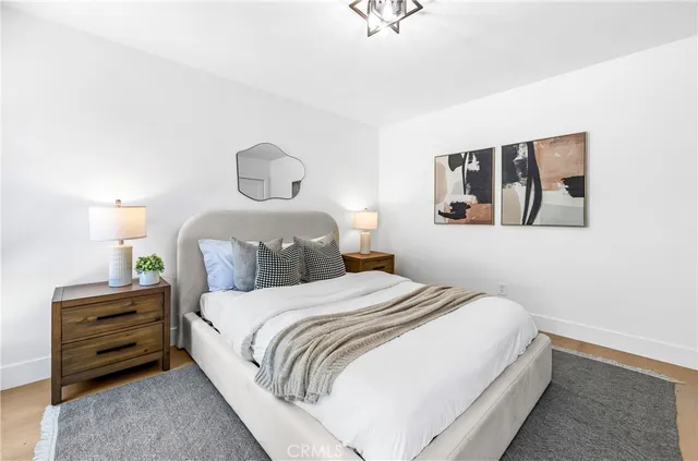 a bedroom with a bed and painting on the wall