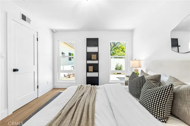 a bedroom with a bed and a large window