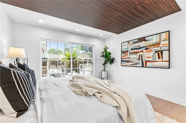 a spacious bedroom with a large bed and a large window