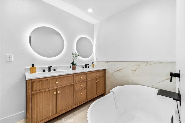 a bathroom with a double vanity sink and a mirror