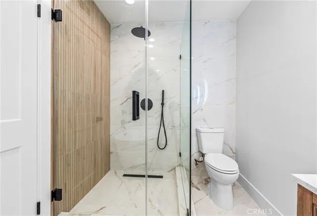a bathroom with a toilet and shower