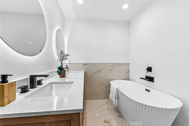 a bath room with a sink and a mirror