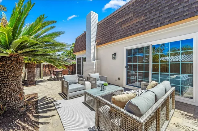 a view of a patio with couches and potted plants