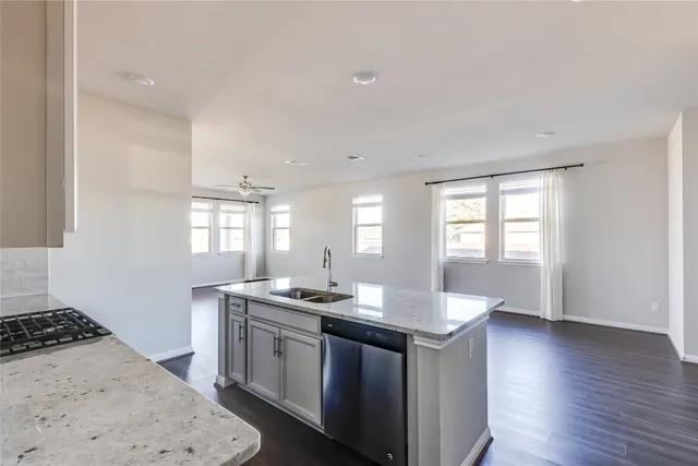 a kitchen with sink stove and cabinets
