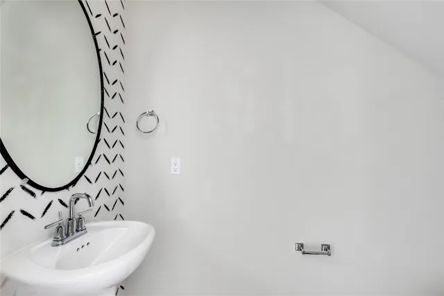 a bathroom with a sink and mirror