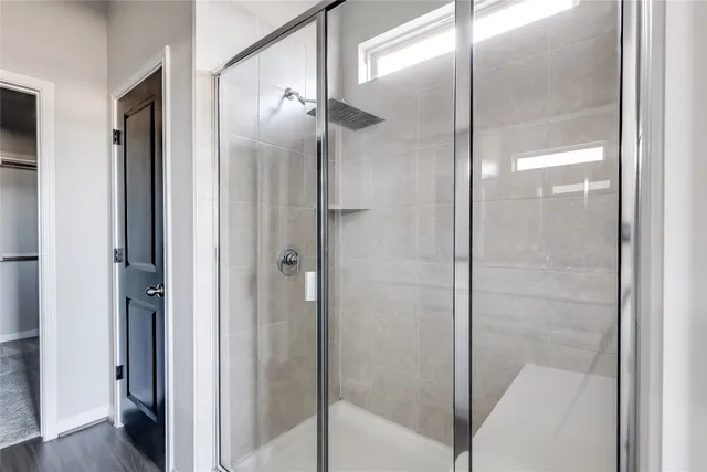 a bathroom with a glass shower door