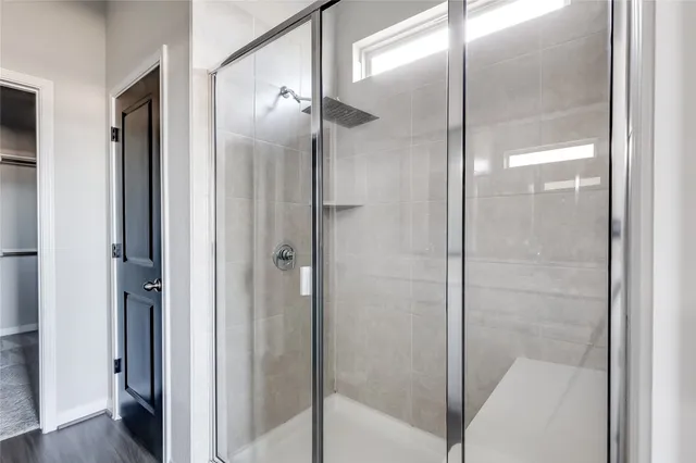 a bathroom with a glass shower door