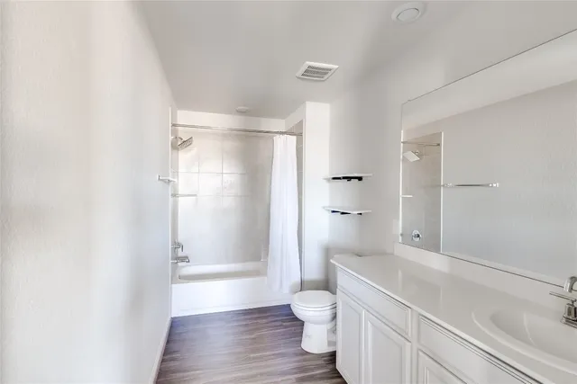 a bathroom with a shower toilet and sink