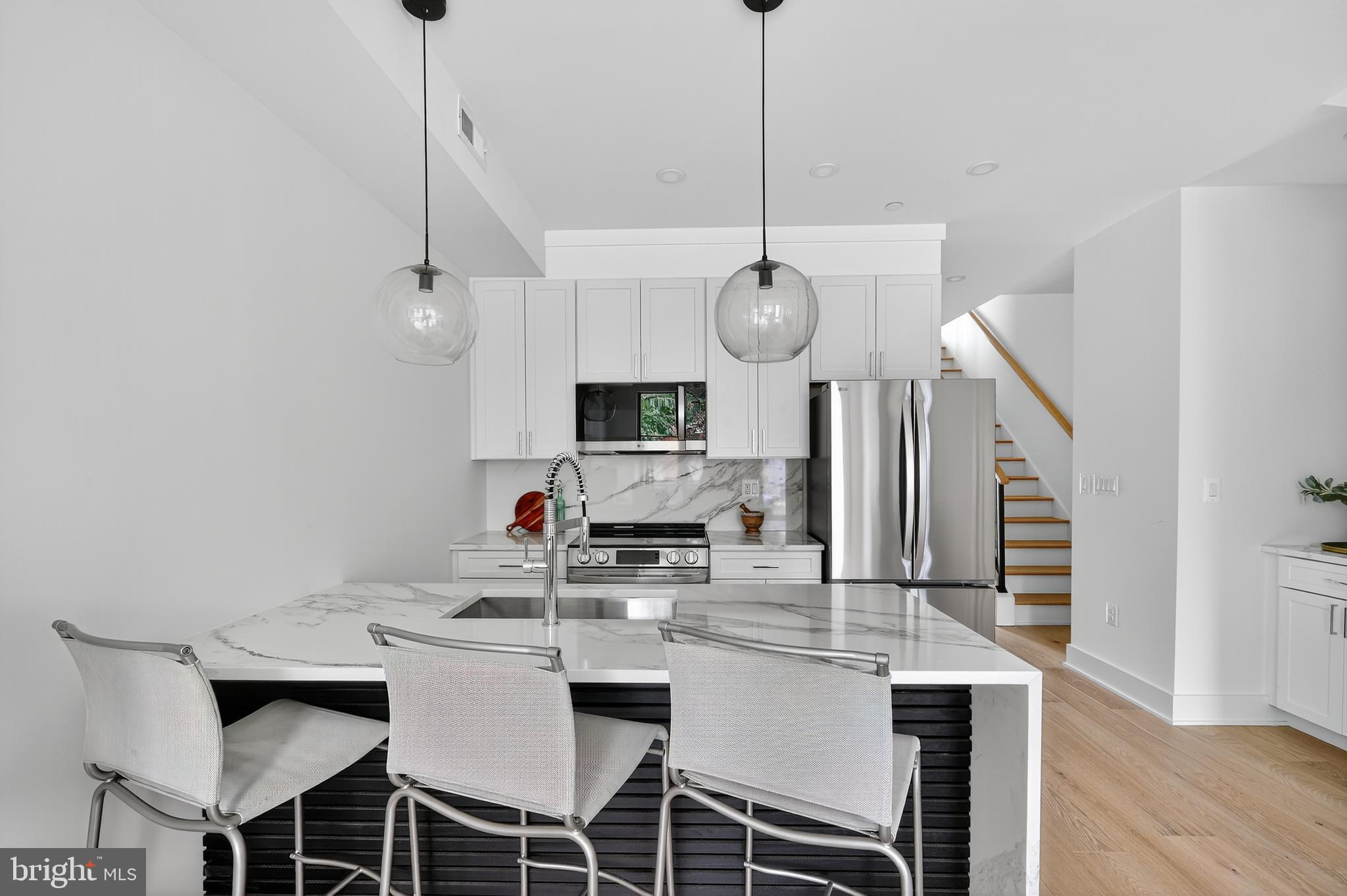 828 21st Street Northeast, Unit 2 Washington, DC 20002 - Photo 11 of 27 a view of a dining room with furniture wooden floor and chandelier