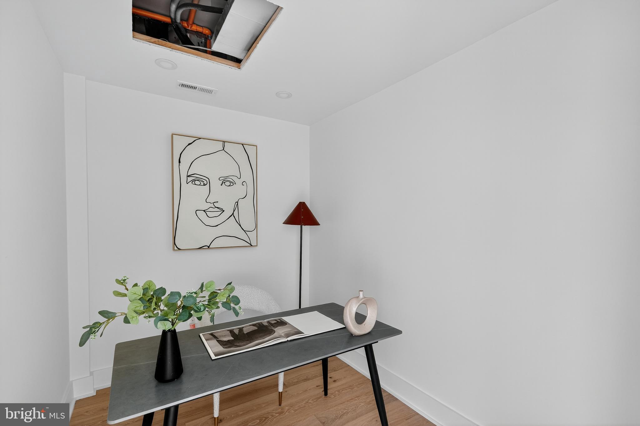 828 21st Street Northeast, Unit 2 Washington, DC 20002 - Photo 12 of 27 a table with a vase and flowers on it