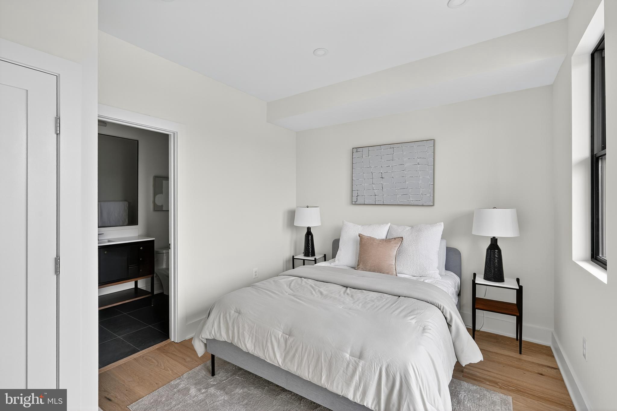 828 21st Street Northeast, Unit 2 Washington, DC 20002 - Photo 17 of 27 a bedroom with a bed and a lamp